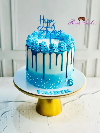 Another angle of the beautiful blue ombre sprinkle drip cake, showing off the rich color and clean lines.