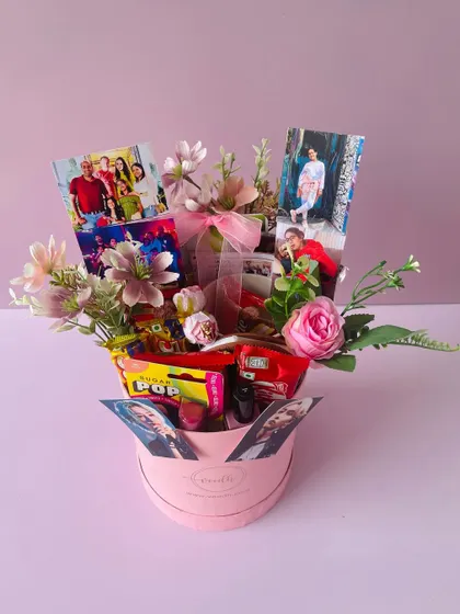 A full view of the round pink birthday box, overflowing with flowers, photos, and goodies. It’s a gift designed to make someone feel truly special.