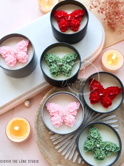 More of my 'Mariposa' butterfly candles, this time featuring red, pink, and green designs. The intricate floral pattern that makes up the butterfly wings is what makes these so unique.