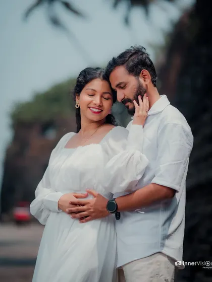 A tender embrace with the bride-to-be gently touching her partner's face. Their closed eyes and soft smiles convey a deep sense of love and contentment.