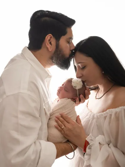 There is such a profound calmness in the love for a newborn. This is a moment from a bright and airy studio newborn session, where I focus on capturing the gentle, intimate connection between new parents and their baby.
