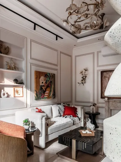 This perspective shows the interplay of light and decor, with a unique leaf-motif chandelier and track lighting creating a warm ambiance. The space feels both grand and intimate, perfect for relaxing or entertaining guests.
