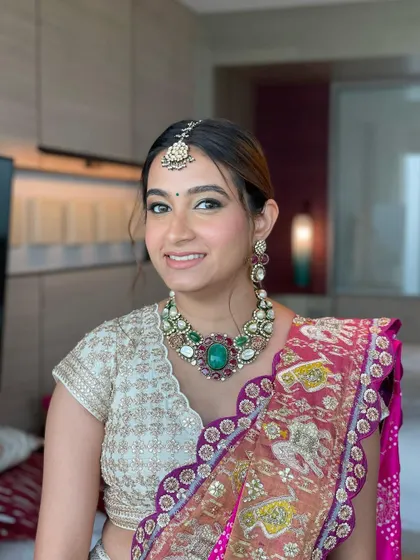 A stylish fishtail braid ponytail for a Haldi ceremony. The use of a traditional gotta string adds a beautiful ethnic detail to this modern hairstyle.