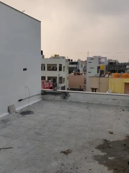 This image shows the 'before' state of a bare concrete terrace. It serves as a blank canvas, illustrating the potential for transformation that we see in every unused outdoor space.