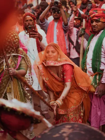 A comprehensive photo series from Lathmaar Holi in Barsana. These images document the unique tradition where women playfully hit men with sticks, recreating a legend of Lord Krishna and Radha. The photos are filled with motion, color, and raw emotion.
