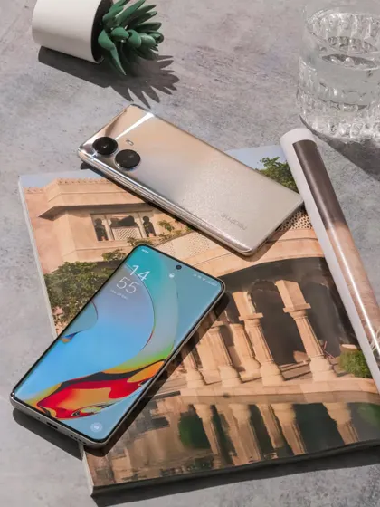 A shot showing both the front and back of the realme 10 Pro+ 5G in a stylish flatlay arrangement.
