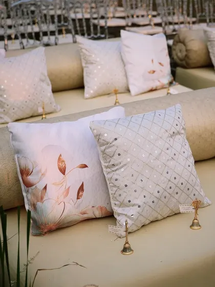 The lounge seating adorned with a mix of printed and sequined cushions, creating a comfortable and stylish space for guests.