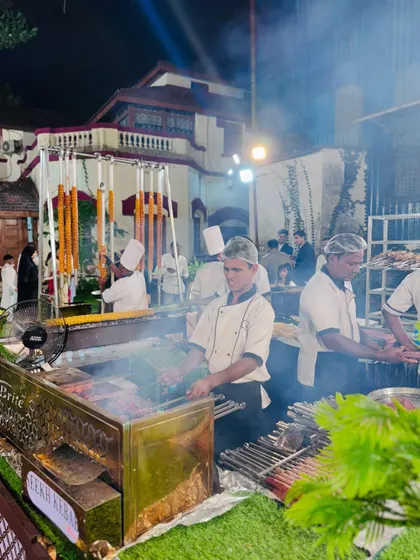 A team of chefs managing the busy barbecue counter, ensuring a constant supply of fresh, hot kebabs.