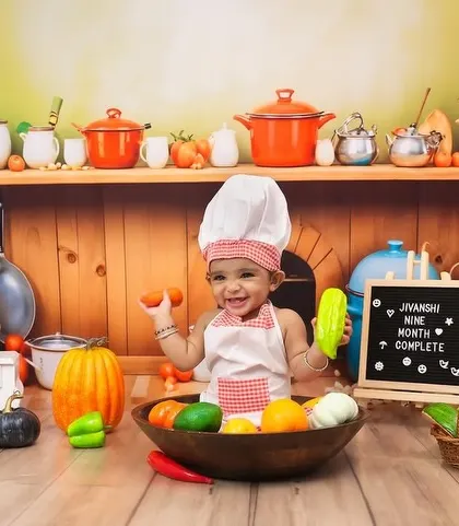 This baby is having a great time playing with the props during her nine-month milestone shoot.