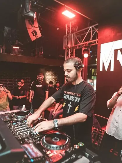 Mixing at "The Secret Project" while club-goers capture the moment on their phones.