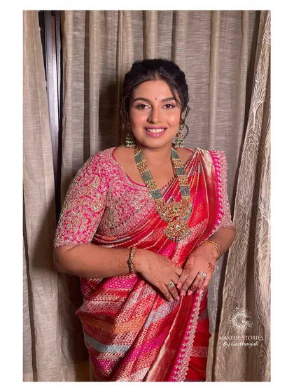 A smiling portrait of Varsha. Her makeup is fresh and luminous, a perfect example of how I create looks that make my clients feel like the best version of themselves.