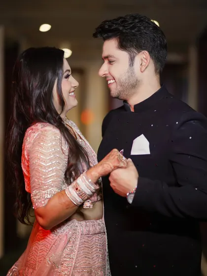 Even in formal attire, we look for those real, unposed smiles. This candid shot from an engagement shoot captures a genuine moment of laughter and connection, proving that you don't have to be stiff and posed to get beautiful portraits.