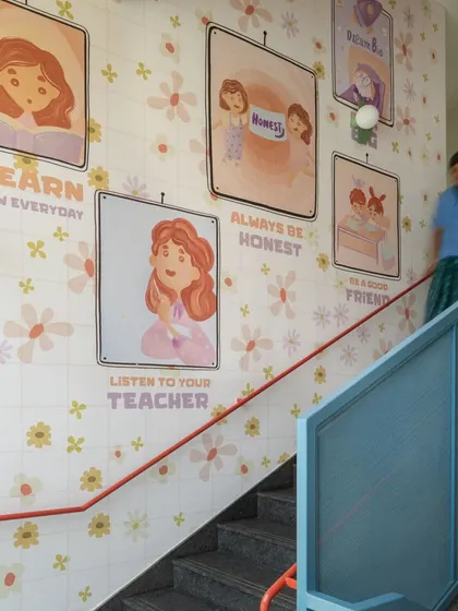 This stairwell is lined with custom tiles featuring illustrations and messages that reinforce good values like "Listen to your teacher" and "Be a good friend." It's a constant, gentle reminder of the school's community ethos.