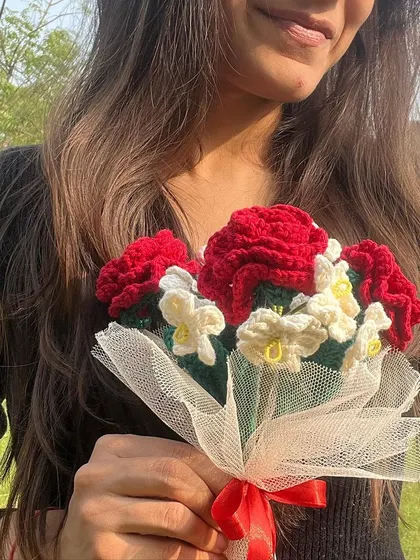 You had me at red roses. A close-up of our beautiful red rose and white flower bouquet, held by a customer.