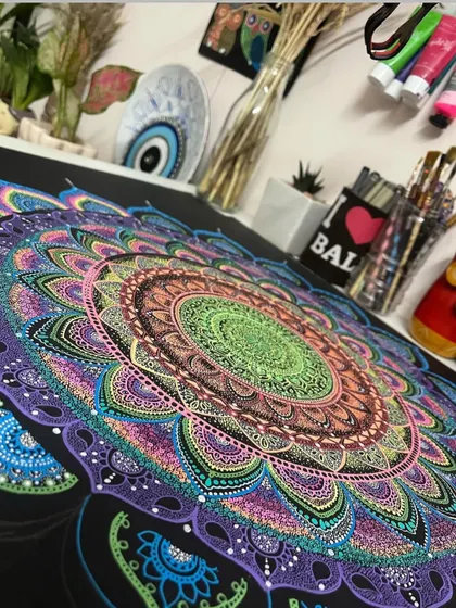A close-up of a large, work-in-progress mandala in my art studio. You can see the layers of color and detail that go into each piece.