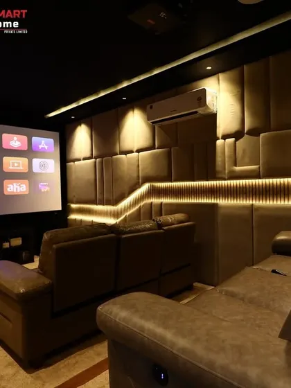 This shot shows the theater in action, with the Apple TV interface on the screen. The warm lighting and comfortable seating make it the perfect place to unwind.