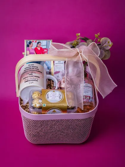 A beautiful birthday hamper curated for a best friend, featuring the personalized mug, a framed photo, chocolates, and pampering items in a stylish pink basket.