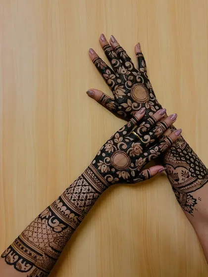 A focus on the back-hand design, which is just as important as the front. This features floral mandalas and dense geometric patterns on the arms.