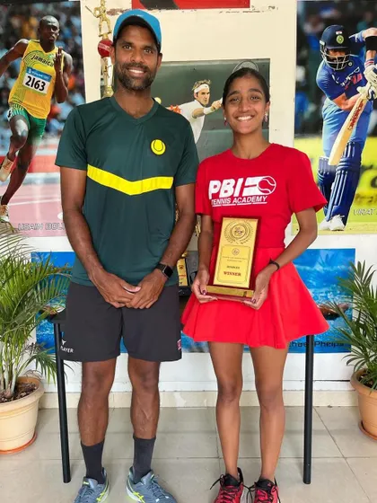 Another shot of our player with her coach, celebrating a significant victory that came after nearly two years of relentless effort and focus.
