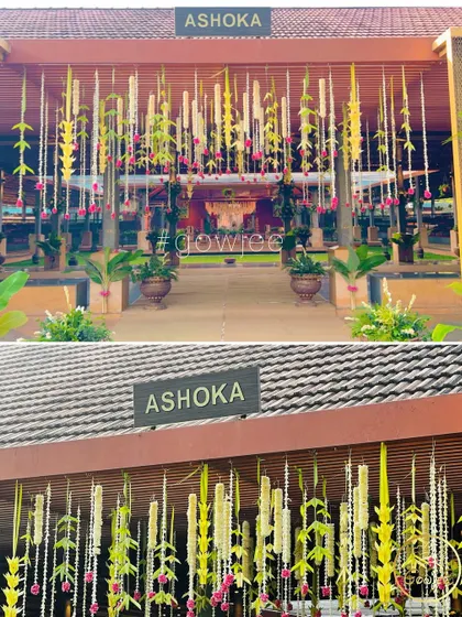 The entrance to the "Ashoka" hall, beautifully decorated with hanging floral arrangements for a wedding.