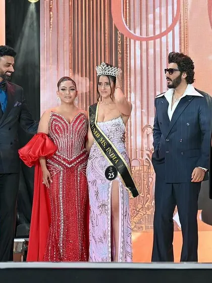 A group photo of the pageant winner with the judges and hosts. This adds credibility and prestige to a model's portfolio.