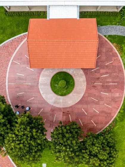 The circular drop-off point at the main entrance, featuring a central green island. The design is both functional for vehicle movement and aesthetically pleasing from an aerial perspective.