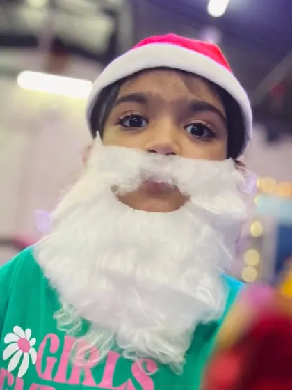 The sparkle and jolly of the holiday season. One of our students gets into the Christmas spirit, dressing up as a mini Santa.