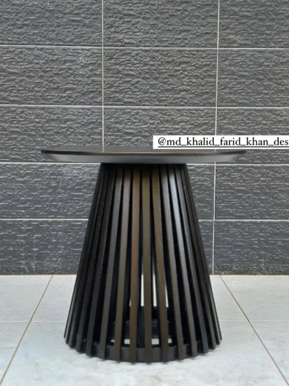 A modern, black slatted side table or coffee table. The minimalist design is versatile and can be used in a variety of contemporary settings.