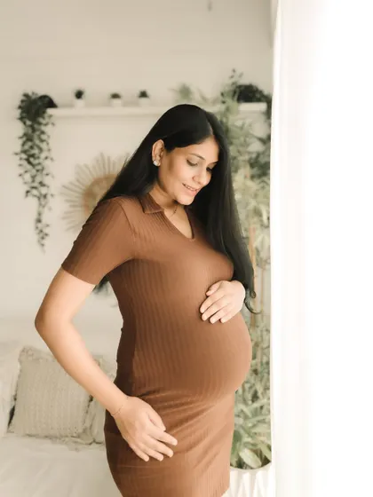 Looking radiant in a comfortable ribbed dress, this mom-to-be shows off her bump with a gentle smile. My studio sessions are designed to be relaxed and feel just like home.