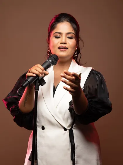 A powerful portrait of the singer, her makeup is subtle yet defining, perfect for a professional headshot.