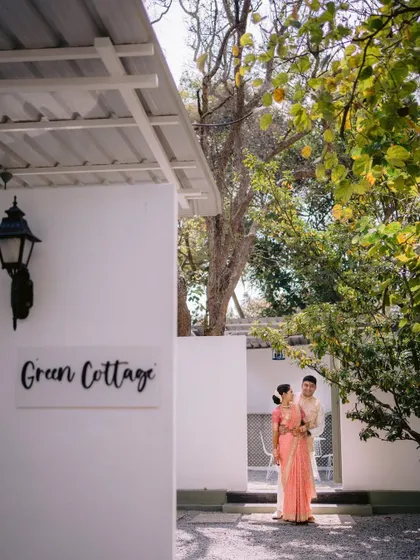 A lovely shot of a couple outside the 'Green Cottage' at our Backyard venue. The clean white walls and surrounding greenery provide a simple yet beautiful backdrop for photos.