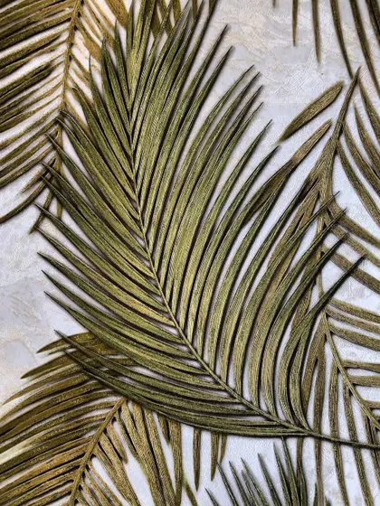 A close-up of a repeating palm leaf pattern wallpaper, showing the texture and detail of the design.