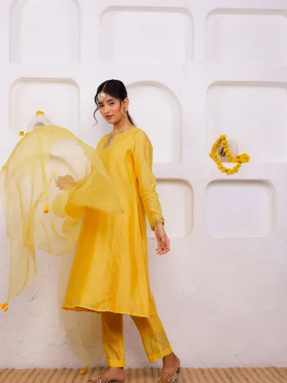 A festive look I styled for A.Projekt, featuring a vibrant yellow salwar suit. The creative direction focused on a clean, minimalist backdrop with pops of yellow flowers to complement the outfit.