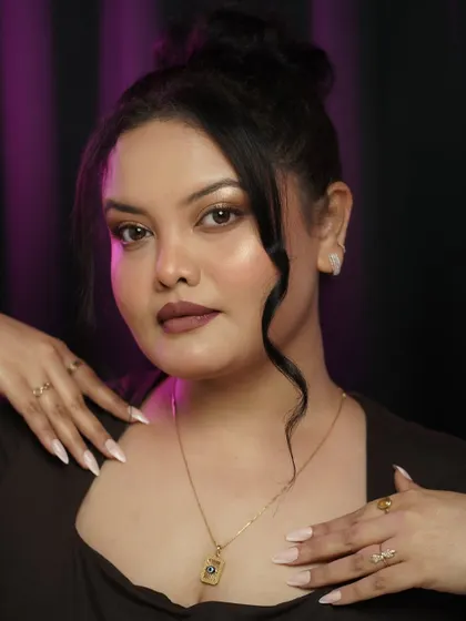 This pose shows off the full makeup look, including the perfectly manicured nails. Self-grooming is about paying attention to every detail to boost your confidence.