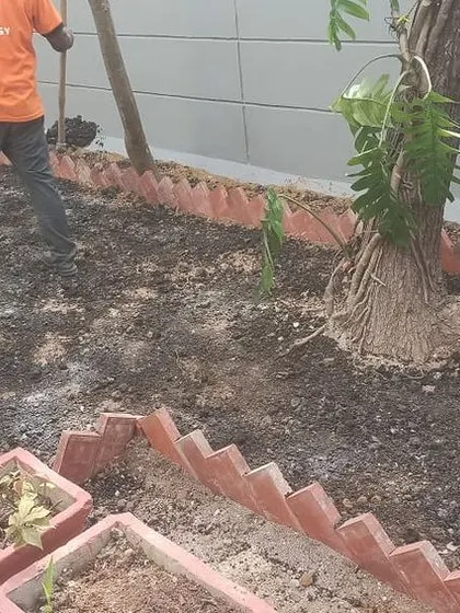 The "before" shot of the backyard garden project. This image shows my team preparing the soil and clearing the area before planting the new garden.