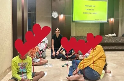 A group of children playing a math game with me during a workshop. My approach is always hands-on and interactive, ensuring every child feels involved and supported.