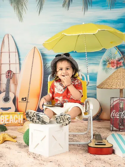 Chilling under a yellow umbrella, this little guy is the king of the beach.