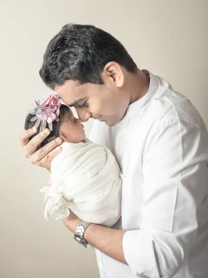 A father and his newborn daughter, nose to nose. This incredibly tender portrait captures the beginning of a lifelong bond.