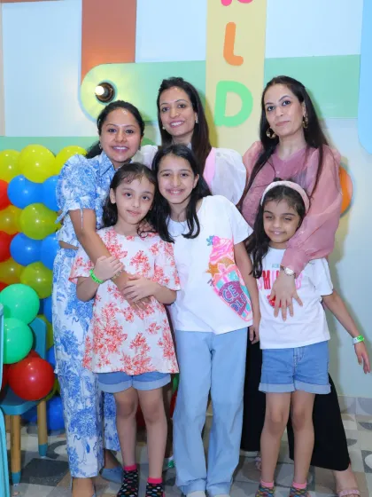 Three generations of family and friends celebrating together, showing that fun at Wobble World is for all ages.