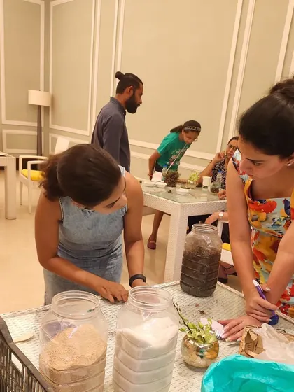 My workshops are completely hands-on. Here, participants at a private DLF Clubs event are busy layering soil and arranging plants, fully engaged in the therapeutic process of creating their own miniature ecosystems.