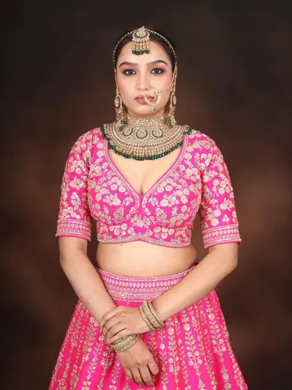 A full-length shot of the bride in her pink lehenga. We teach you how to create a complete, cohesive bridal look from head to toe.