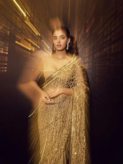 An artistic, motion-blur shot of a glamorous gold saree look. During our portfolio shoots, we experiment with creative photography to produce unique and eye-catching images for your book.