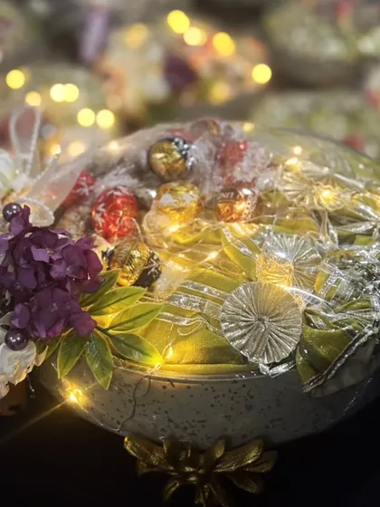 A close-up of one of my illuminated gift hampers, ready for a bulk delivery. The warm glow of the fairy lights adds a touch of magic and elegance, making it a truly impressive gift for corporate clients or special occasions.