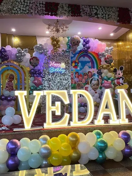 The full, elaborate stage for Vedant's first birthday, showing the scale of the decoration and the multiple themes combined into one grand setup.
