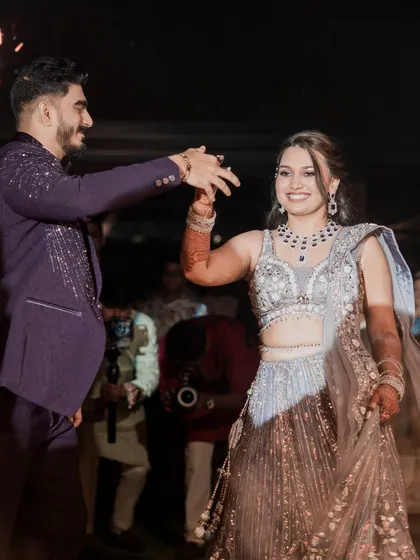The couple's first dance. This action shot captures the movement of the bride's lehenga and her joyful expression, showing that my makeup and hair styling holds up beautifully.