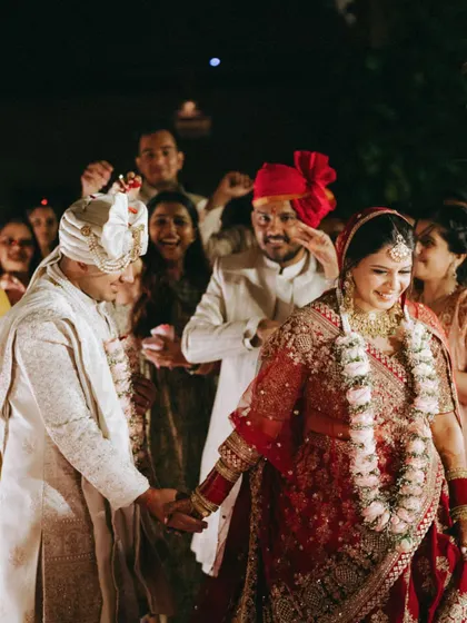 A candid moment of the couple walking together after their ceremony, surrounded by the happy faces of their loved ones.