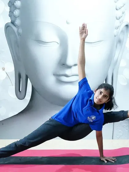A young student demonstrates a beautiful side plank variation, showing that yoga is for all ages and abilities.