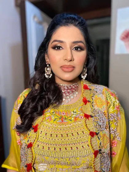 A close-up of Sonia's makeup, showing the flawless base and the warm, shimmery eye makeup.