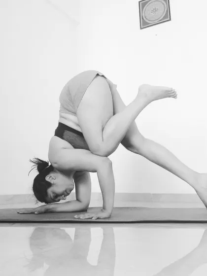 A black and white still of a funky Pincha variation. Exploring different leg positions helps you understand your center of gravity.
