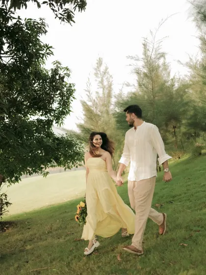 A candid moment of the couple walking and talking in a beautiful, natural setting, full of life and movement.